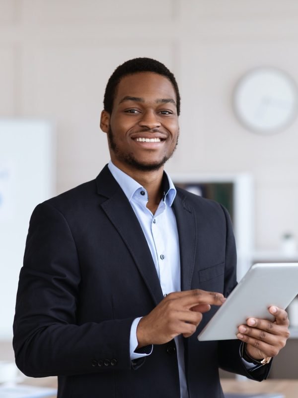smiling-black-entrepreneur-holding-digital-tablet-office-interior.jpg smiling-black-entrepreneur-holding-digital-tablet-office-interior.jpg